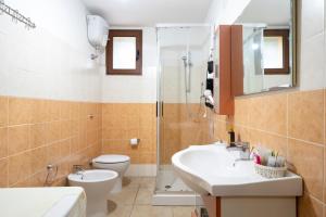 a bathroom with a toilet and a sink and a shower at Il Giglio in Cardedu +15 photos