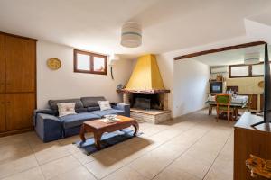 a living room with a blue couch and a fireplace at Il Giglio in Cardedu