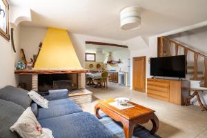 a living room with a blue couch and a tv at Il Giglio in Cardedu