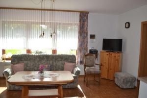 a living room with a couch and a table at Ferienwohnung Meins in Friesoythe