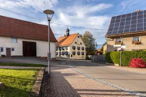 a street with a street light and a building with solar panels at Schwarzwald - Ferienhaus in Villingen-Schwenningen