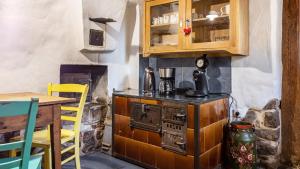 a kitchen with an old stove and a table at Schwarzwald - Ferienhaus in Villingen-Schwenningen