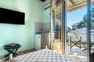 a room with a view of a kitchen and a balcony at Old Boat 12 in Nikiana