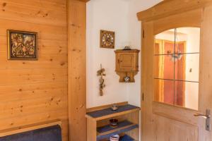 a room with a wooden wall with a door at Apartments Christa App A in Ortisei