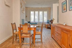 a dining room and living room with a table and chairs at La Baule in La Baule