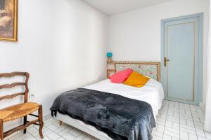 a bedroom with a bed and a chair at La Baule in La Baule