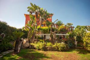 a house with a garden in front of it at Casa Petunia in Sarroch