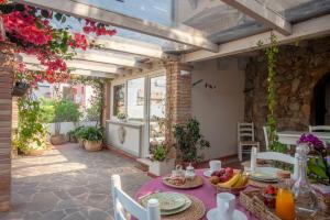 a patio with a table with fruit on it at Casa Petunia in Sarroch