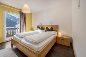 a bedroom with two beds and a large window at Apartment Sciadules in Ortisei