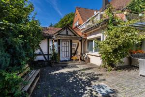 a small white house with a door and a yard at Haus Sonnenberg in Willingen