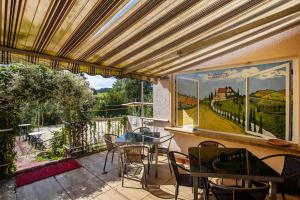 a patio with a table and chairs and a window at Haus Sonnenberg in Willingen