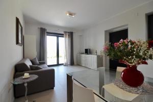 a living room with a vase of flowers on a glass table at Amazing Assisi in Assisi