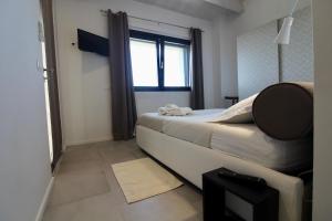 a small bedroom with a bed and a window at Amazing Assisi in Assisi +35 photos