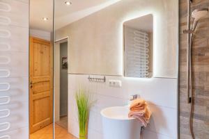 a bathroom with a sink and a mirror at Landhaus Lucia in Oberau +19 photos