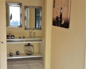 a bathroom with a sink and a mirror at Ferienwohnung Laura in Langenargen +24 photos
