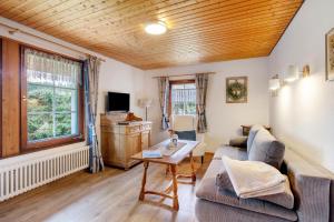 a living room with a couch and a table at Altes Zollhüsli in Schluchsee