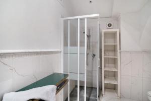a white bathroom with a shower and a sink at Inglese, borgo dei pescatori in Cervo +17 photos