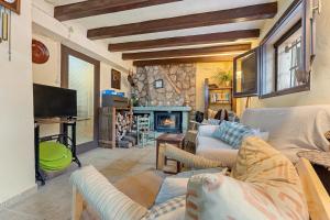 a living room with couches and a fireplace at Priorat Tranquil in Lloá