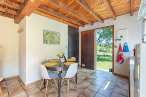 a kitchen and dining room with a table and chairs at Gite Lieuj in Peyrouse +12 photos