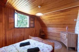 a bedroom with a bed in a wooden room at Gite Lieuj in Peyrouse