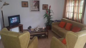 a living room with two couches and a tv at Villa Consuelo in Cambrils
