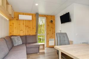 a living room with a couch and a table at Haus Heike in Untergriesbach