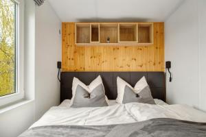 a bedroom with a bed with white sheets and pillows at Haus Heike in Untergriesbach