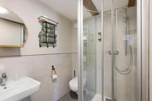 a bathroom with a shower and a toilet and a sink at Zeihäänger Stubb in Schwalmstadt +112 photos