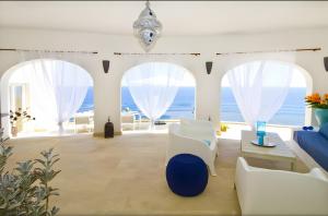 a living room with a view of the ocean at Villa Blanca in Capdepera +12 photos