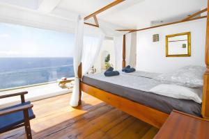 a bedroom with a bed and a large window at Villa Blanca in Capdepera
