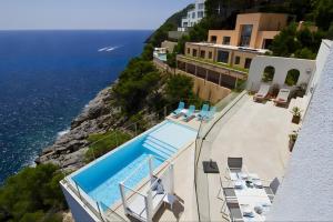 an overhead view of a pool and the ocean at Villa Blanca in Capdepera