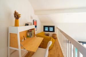 a living room with a yellow couch and a table at Villa Xarma, A Deux Pas de l’Océan in Seignosse