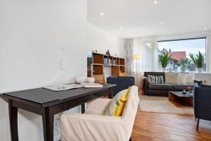 a kitchen and living room with a table and chairs at Kapps Haus in Langenargen