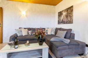 a living room with a couch and a table at Ferienwohnung, 55qm in Herscheid
