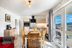 a dining room and kitchen with a table and chairs at Café Pension Pfaus Heidburg in Mühlenbach