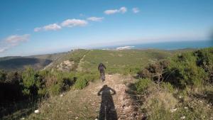 a person riding a bike on a dirt trail at Oasi Beach Hotel in Vieste