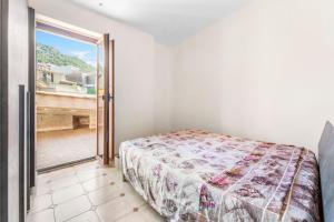 a bedroom with a bed and a door to a balcony at Arbus Aventino Centrale in Arbus