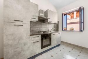 a kitchen with stainless steel appliances and a window at Arbus Aventino Centrale in Arbus +12 photos