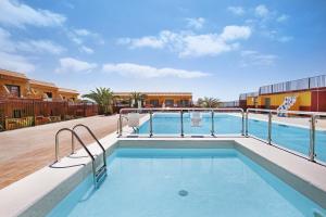 a swimming pool at a resort with a building at Casa Nicole Sea View in Costa de Antigua
