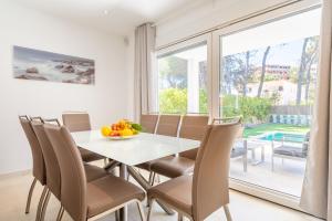 a dining room with a table and chairs and a large window at The Tower Villa in El Toro