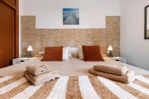 a bedroom with a large bed with towels on it at Casa Nicole Sea View in Costa de Antigua +27 photos
