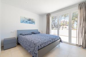 a bedroom with a bed and a large window at The Tower Villa in El Toro +19 photos