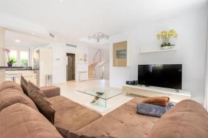 a large living room with a couch and a tv at The Tower Villa in El Toro