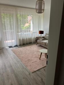 a living room with a couch and a table at Herzlichstharz - Klein und Fein in Bad Lauterberg