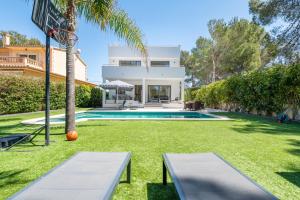 a villa with a swimming pool and a basketball hoop at The Tower Villa in El Toro
