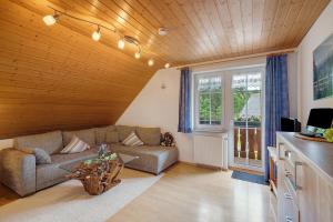 a living room with a couch and a window at Baschijörgenhof in Sankt Peter