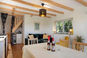 a kitchen and living room with a table with wine bottles on it at Gallushof in Lauterbach