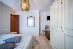 a bedroom with a bed and a mirror at La terrazza sul faro in Lignano Sabbiadoro