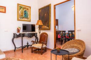 a living room with a desk and chairs at Villa Frontera in Sóller