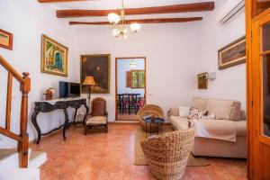 a living room with a couch and a table at Villa Frontera in Sóller +33 photos